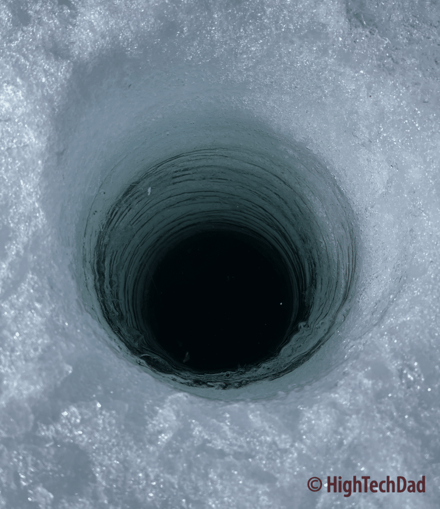The hole in the goes to darkness - ice fishing